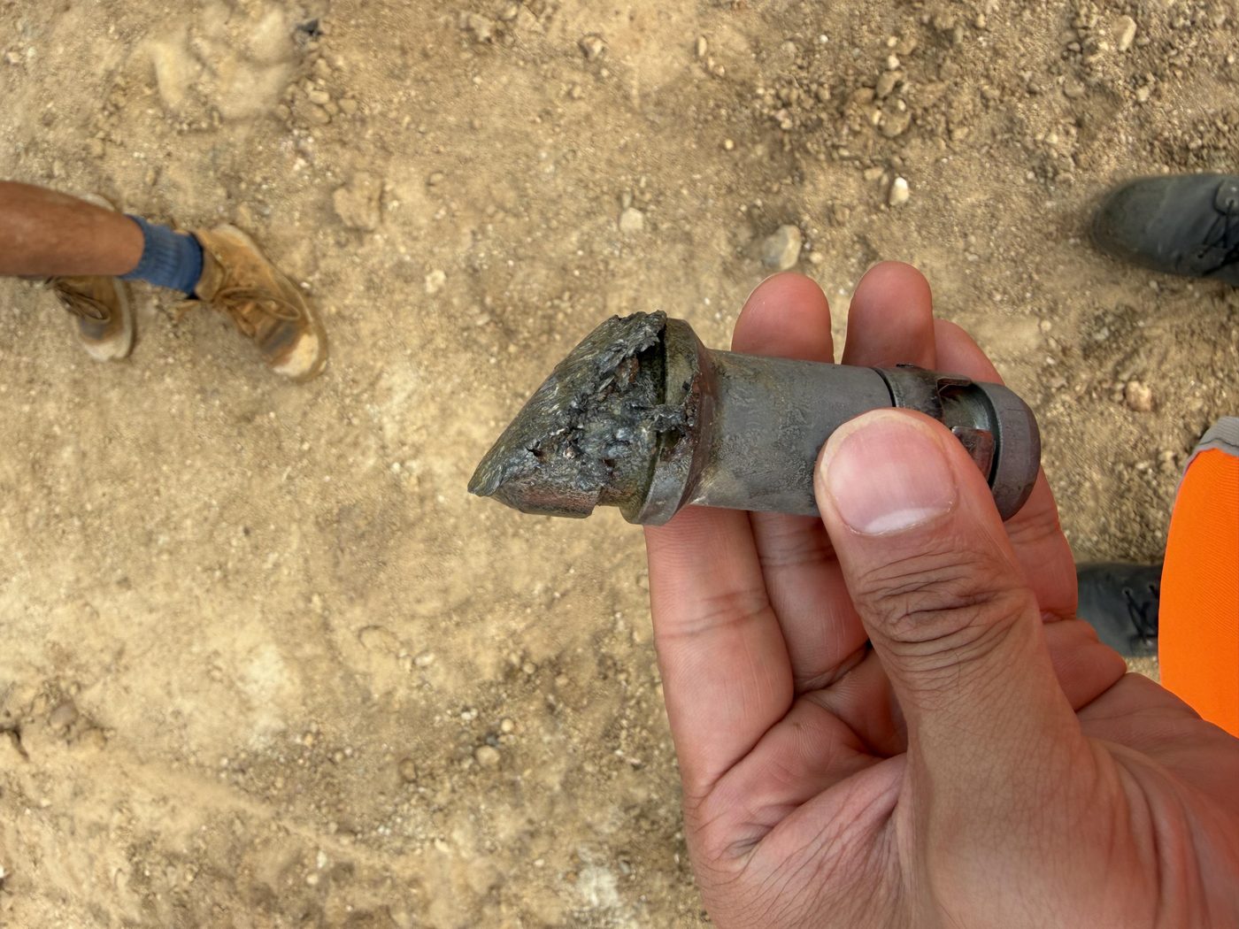 Tungsten carbide drill tooth worn down in the harder rock